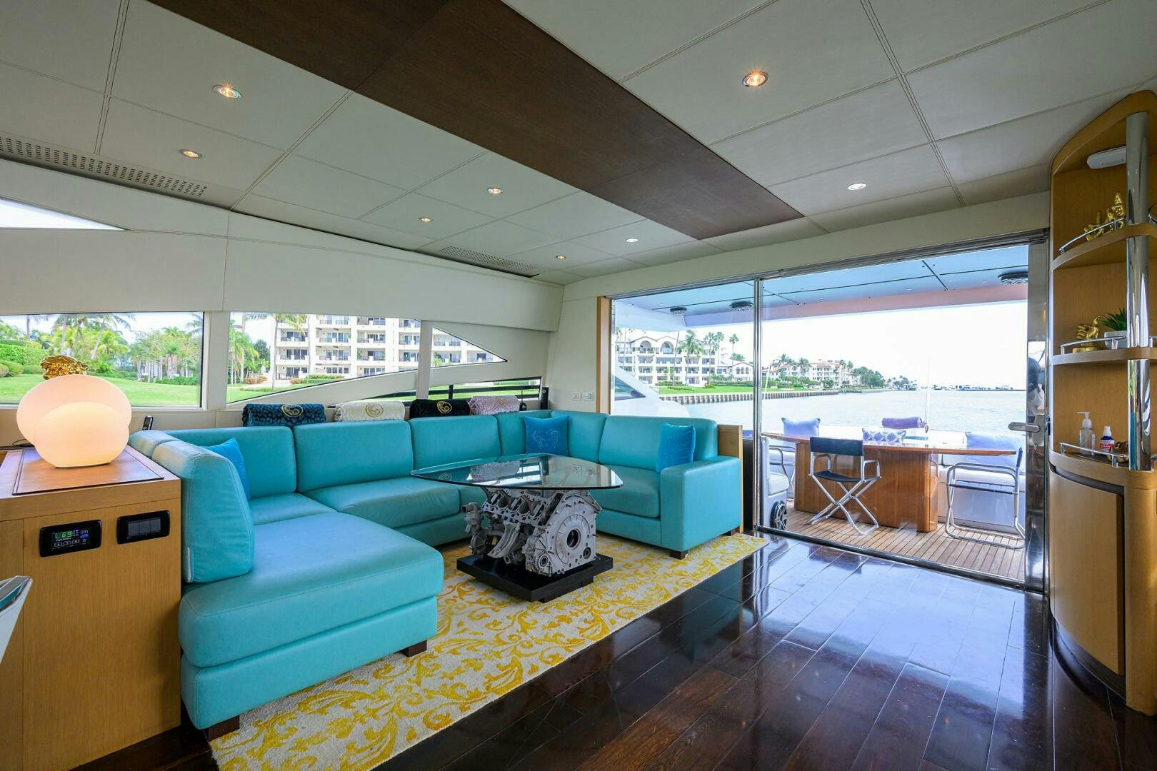 a living room with a blue couch aboard MIURA Yacht for Sale