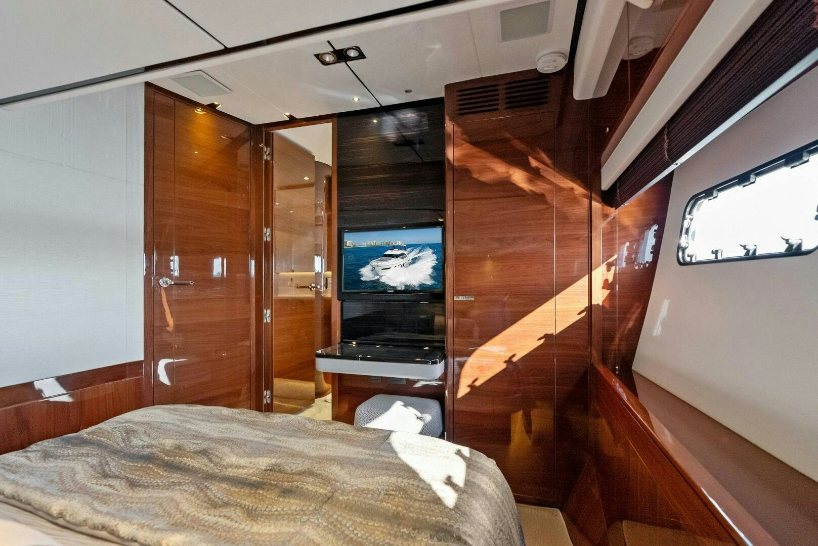 a bed and a television in a room aboard AMICI Yacht for Sale