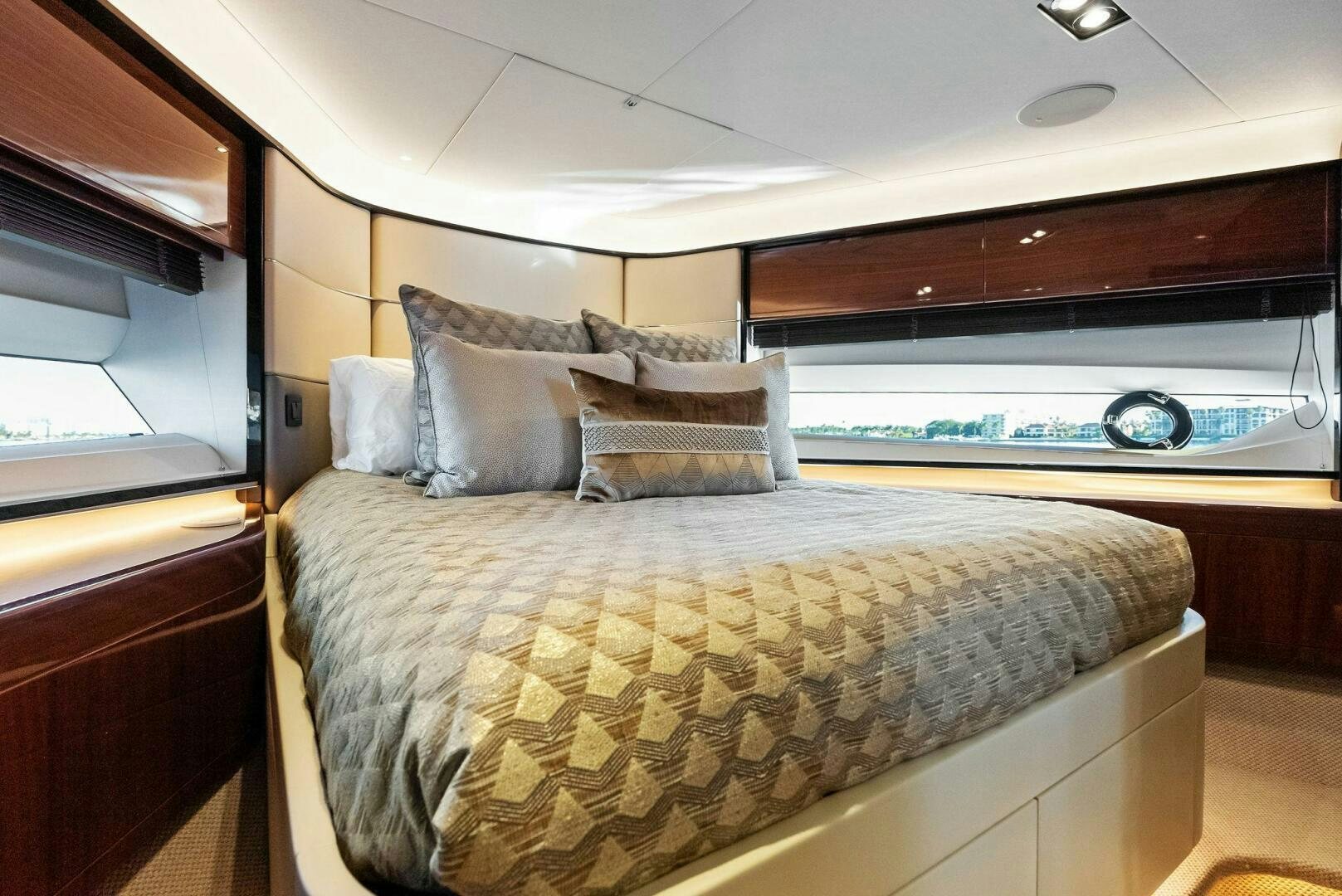 a bed with a large mirror above it aboard AMICI Yacht for Sale
