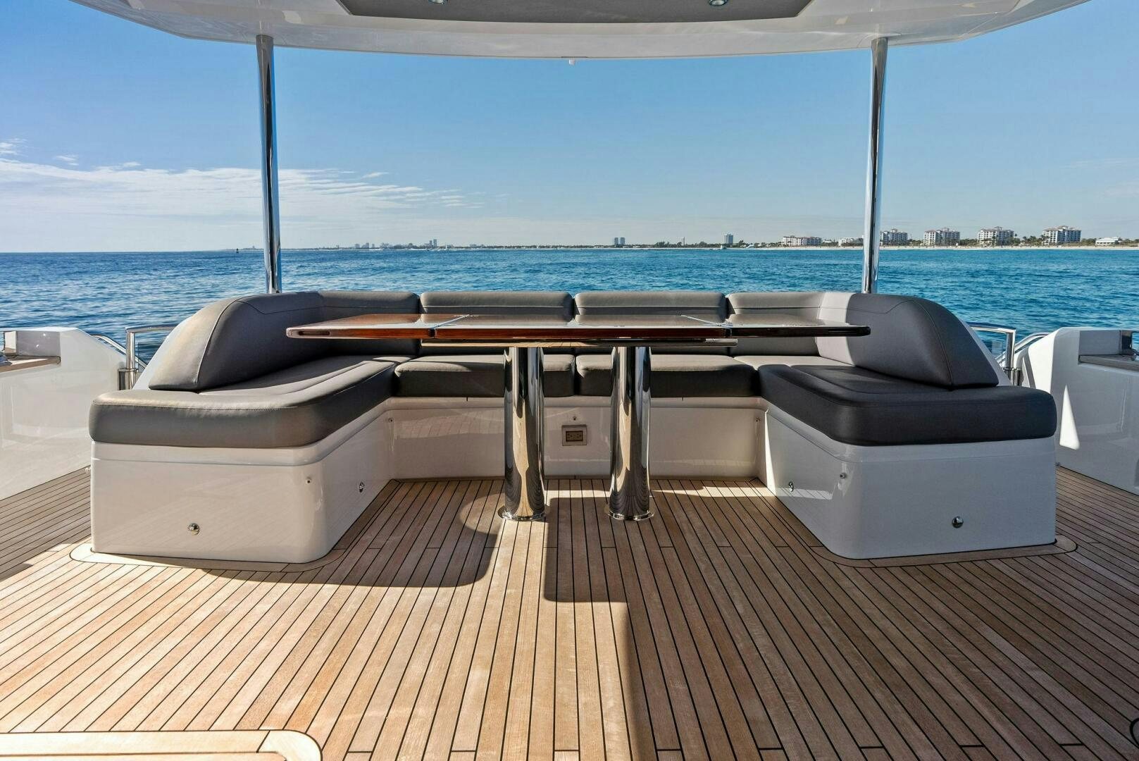 a deck with a large bed and a large body of water aboard AMICI Yacht for Sale