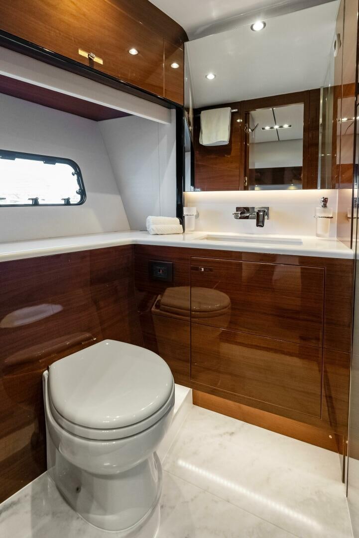 a bathroom with a toilet and a sink aboard AMICI Yacht for Sale