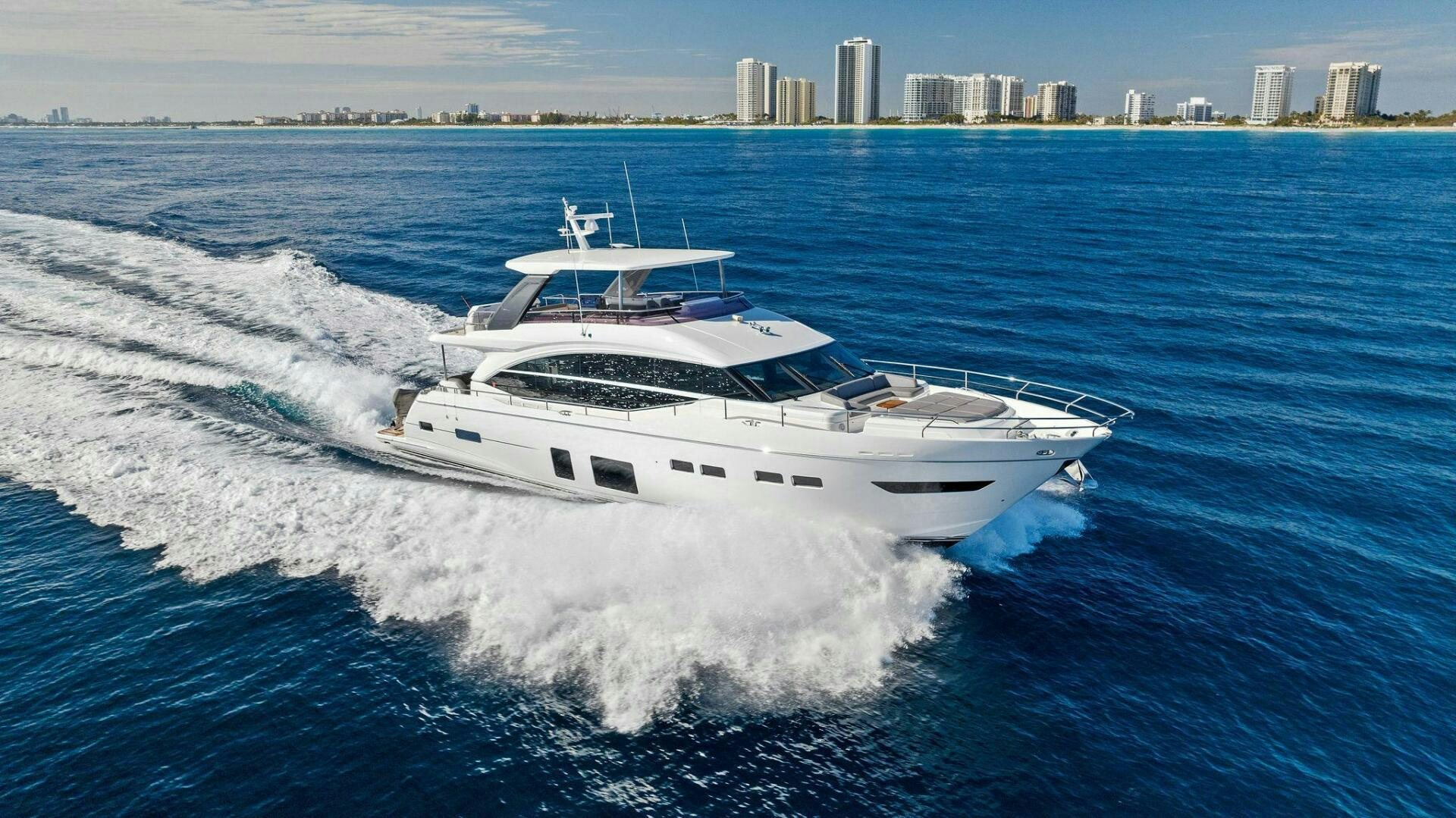 a white yacht on the water aboard AMICI Yacht for Sale