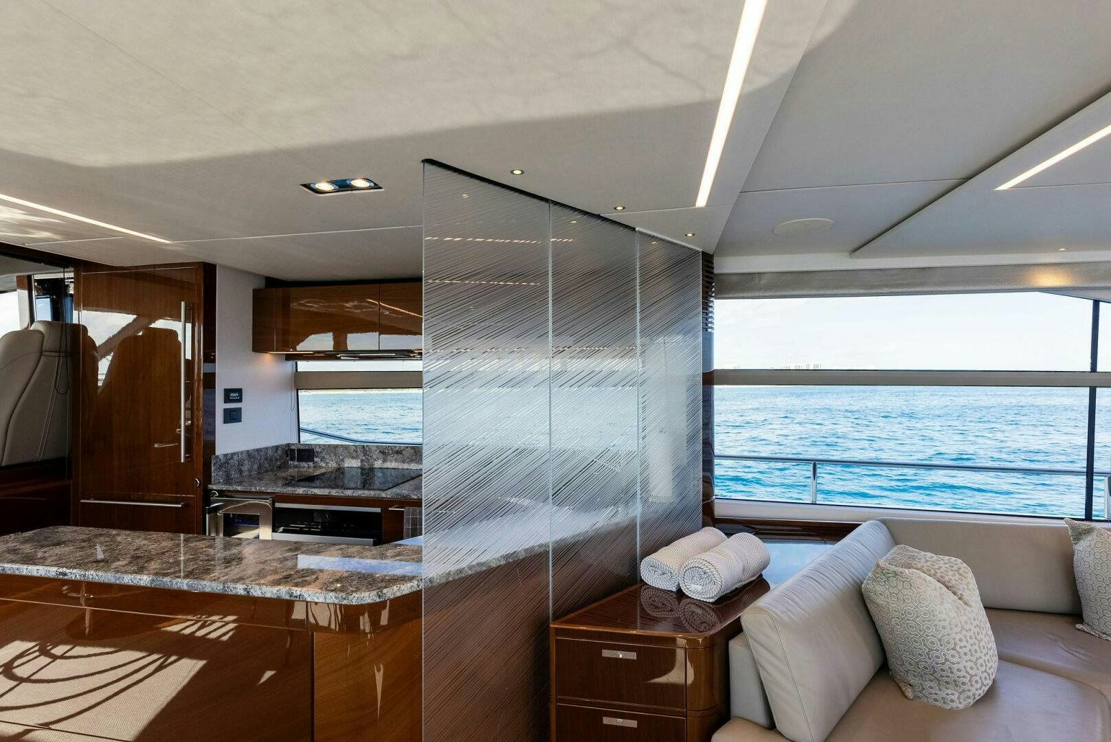 a room with a bed and a large glass wall aboard AMICI Yacht for Sale