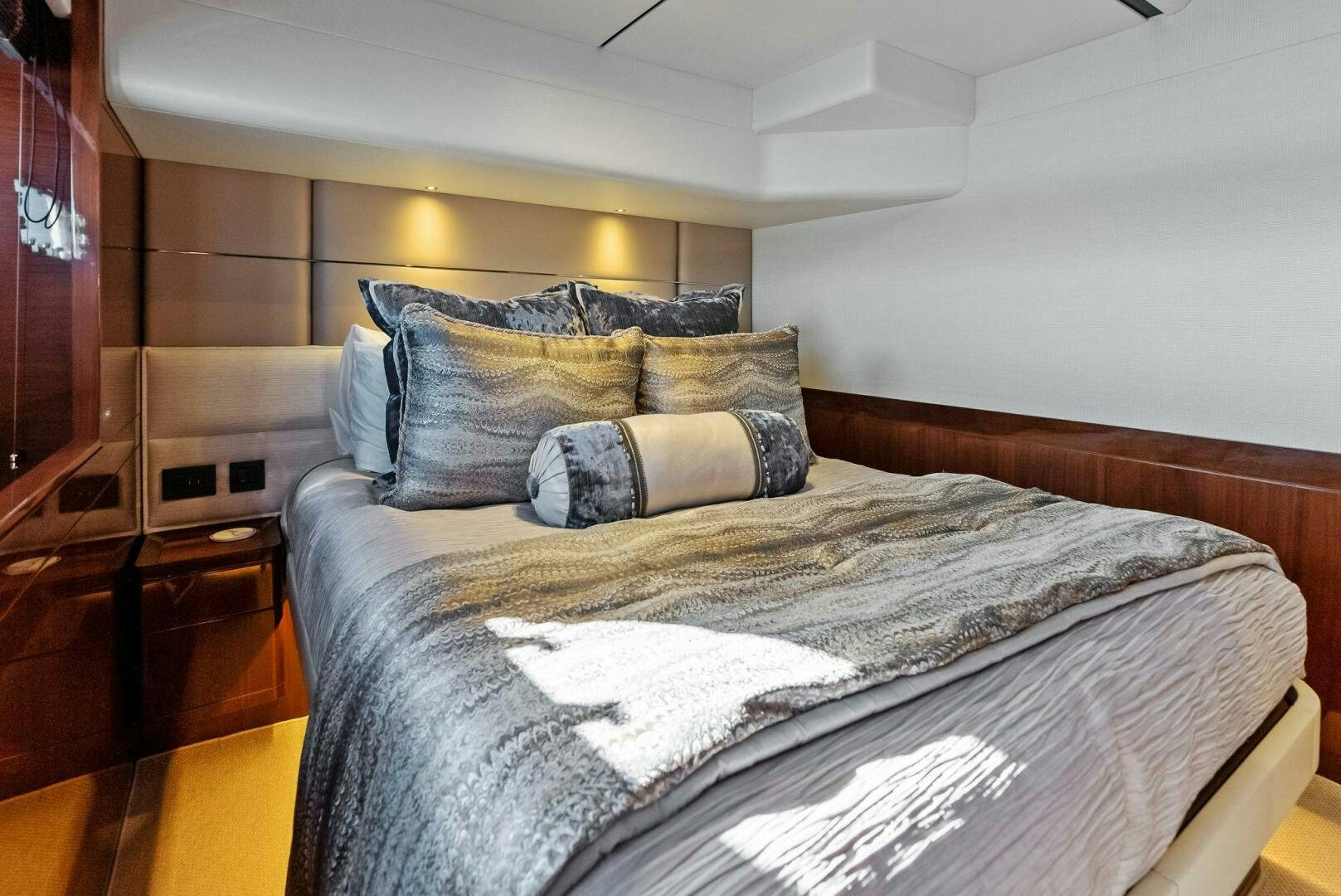 a bed with a white comforter aboard AMICI Yacht for Sale