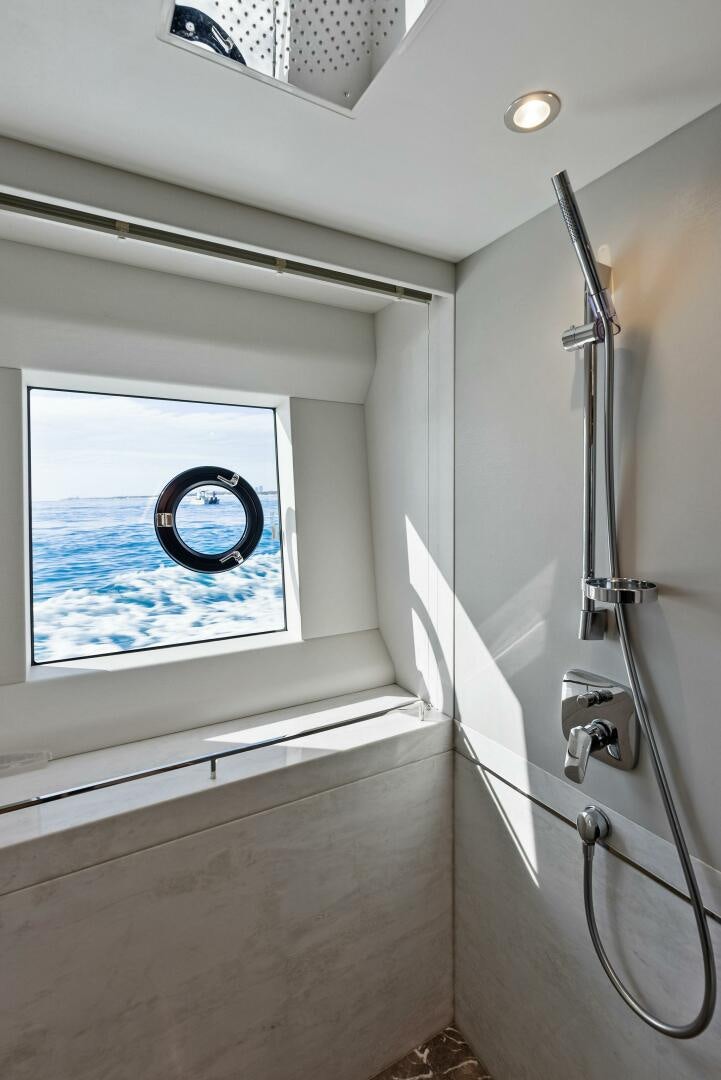 a shower unit with a window aboard AMICI Yacht for Sale