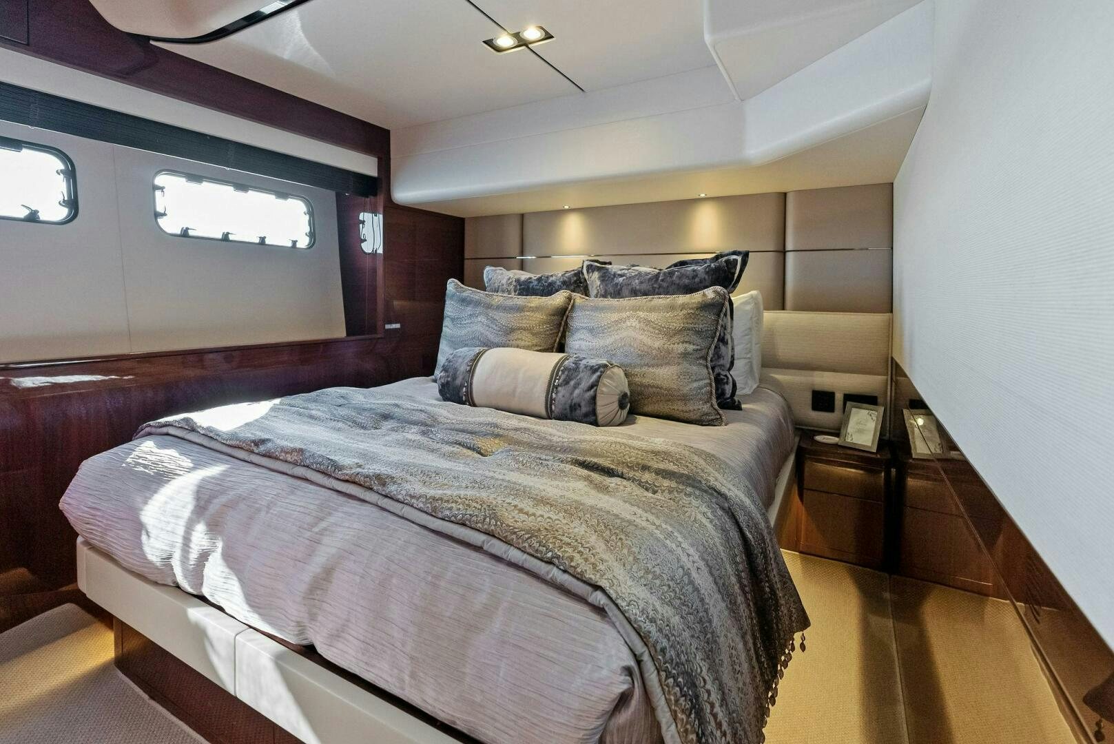 a bed with a blue comforter aboard AMICI Yacht for Sale