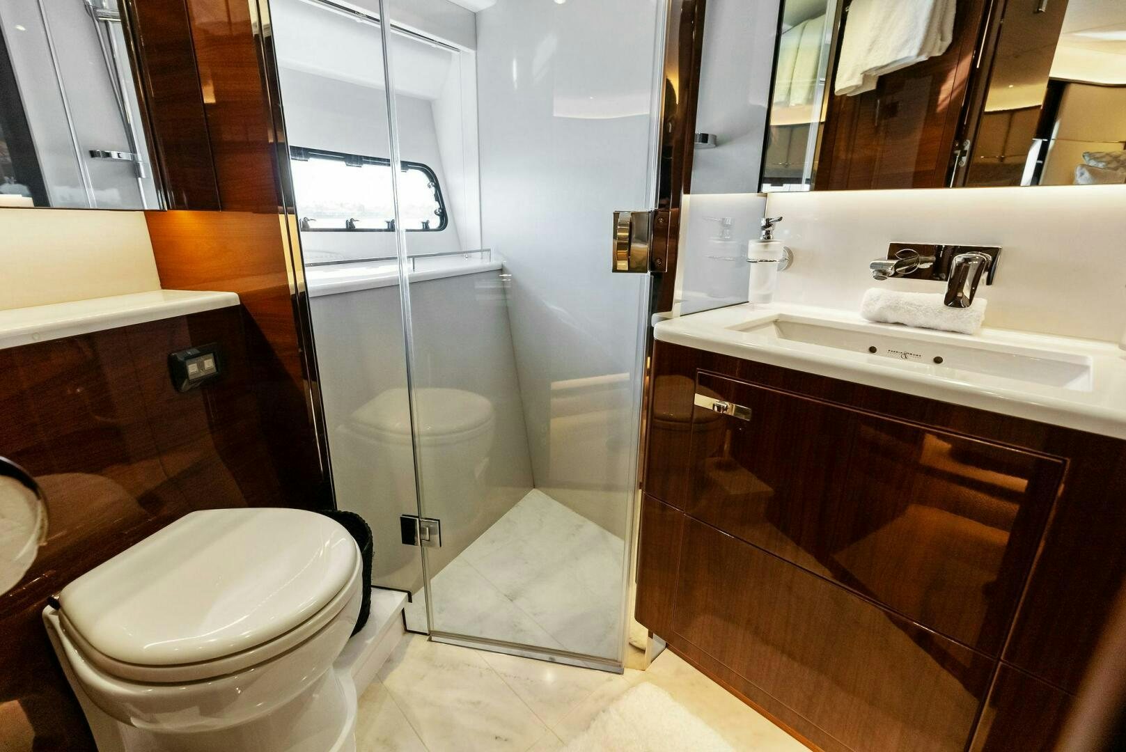 a bathroom with a glass shower aboard AMICI Yacht for Sale