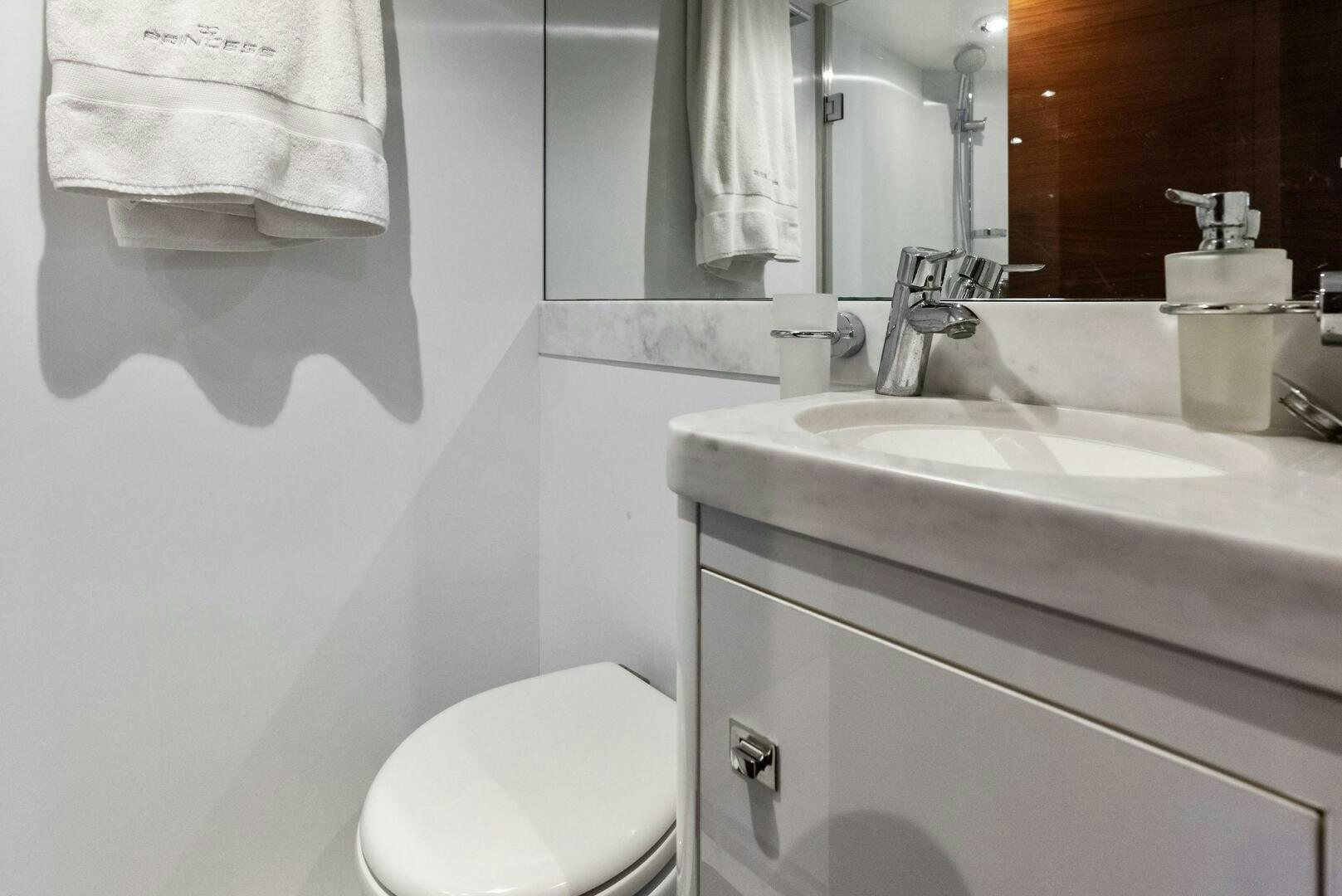a bathroom with a sink and toilet aboard AMICI Yacht for Sale