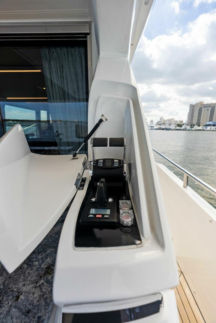 a white boat with a black seat aboard AMICI Yacht for Sale
