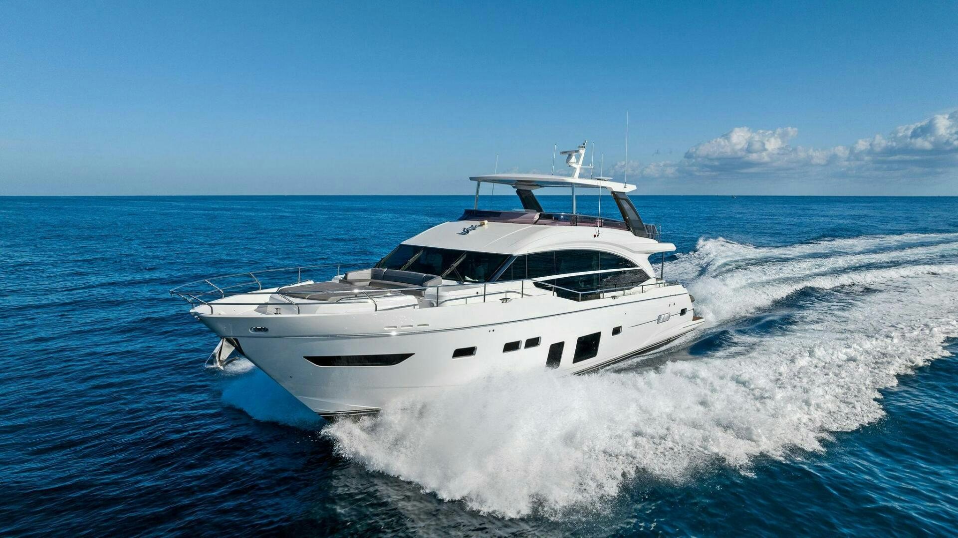 a white yacht on the water aboard AMICI Yacht for Sale