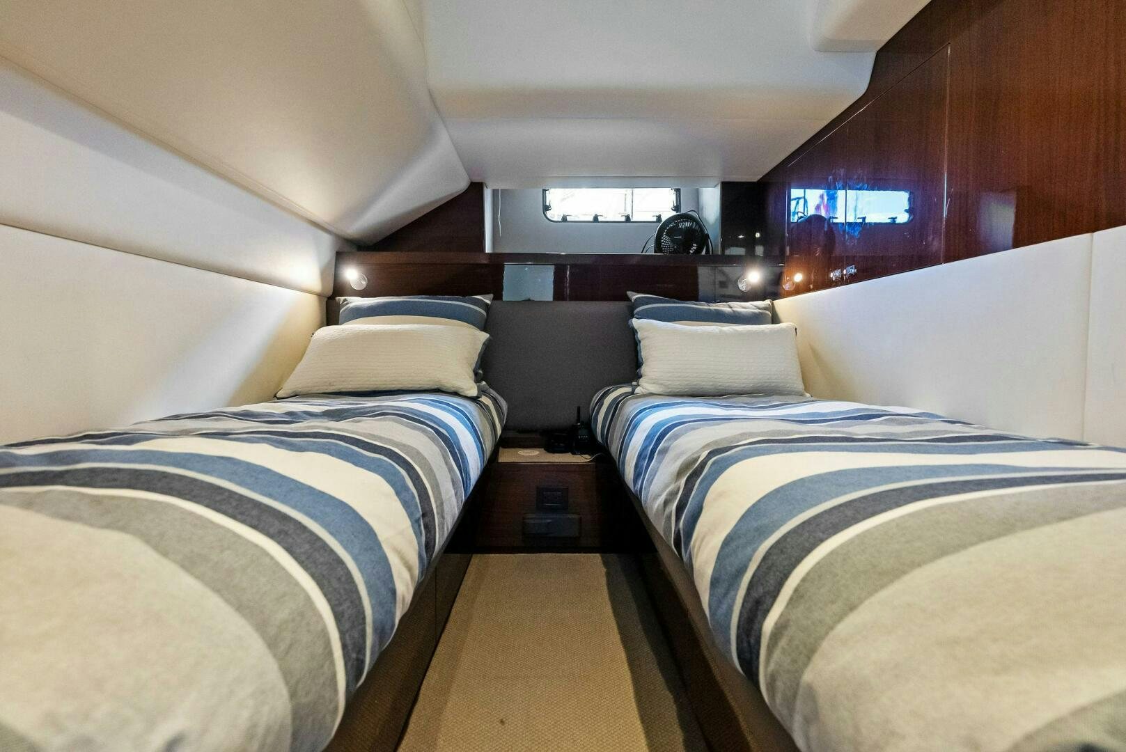 a couple of beds in a room aboard AMICI Yacht for Sale