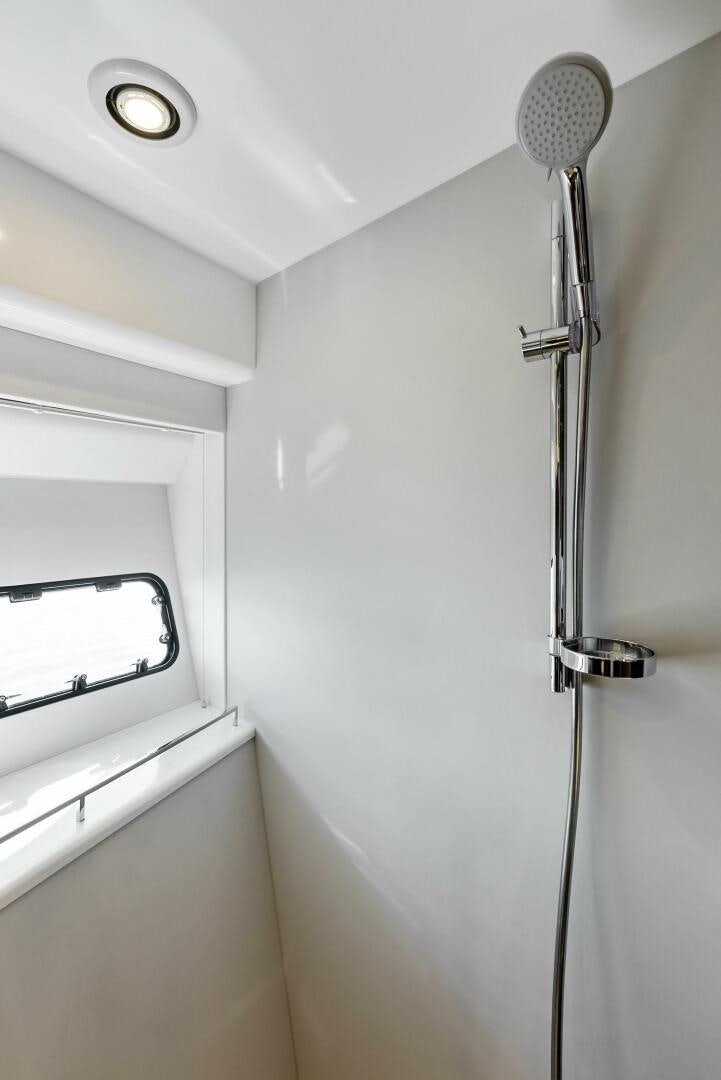 a shower unit in a bathroom aboard AMICI Yacht for Sale