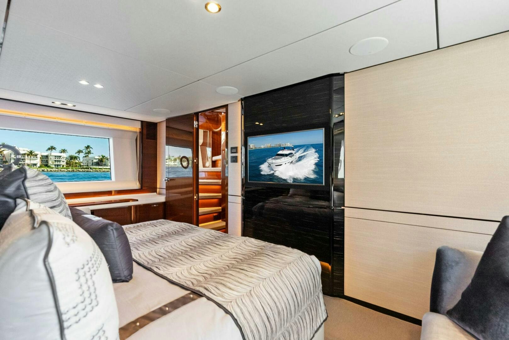 a room with a tv and a bed aboard AMICI Yacht for Sale