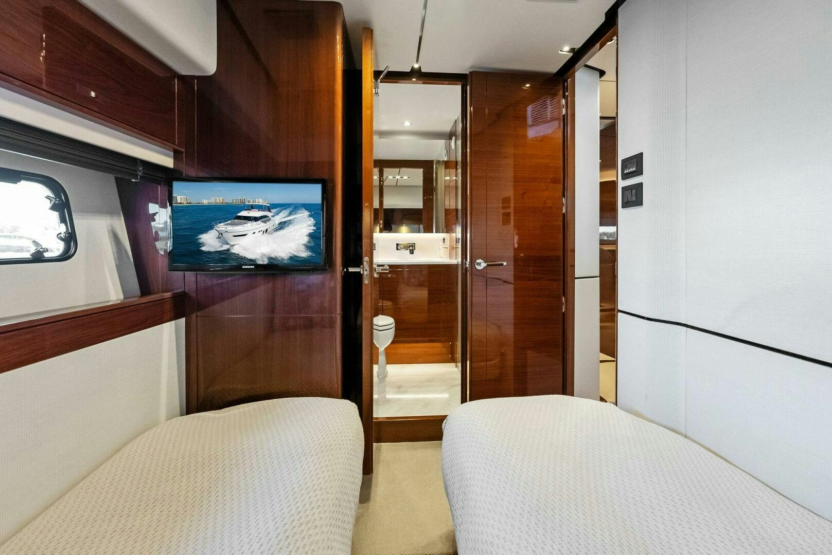 a room with a bed and a television aboard AMICI Yacht for Sale