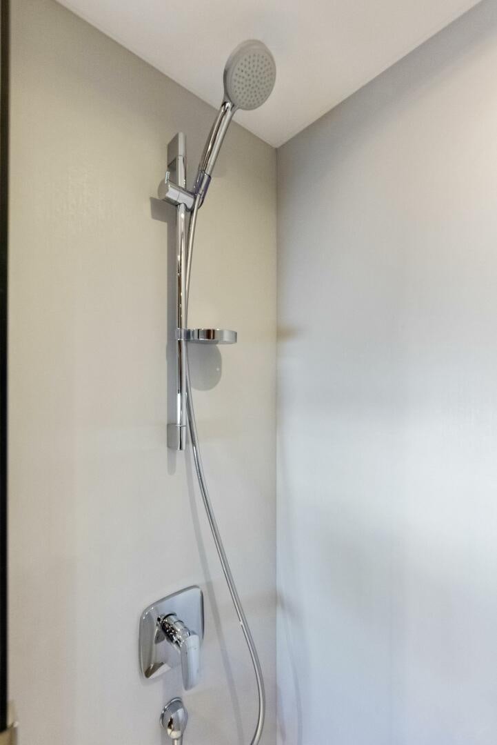 a shower head with a metal handle aboard AMICI Yacht for Sale