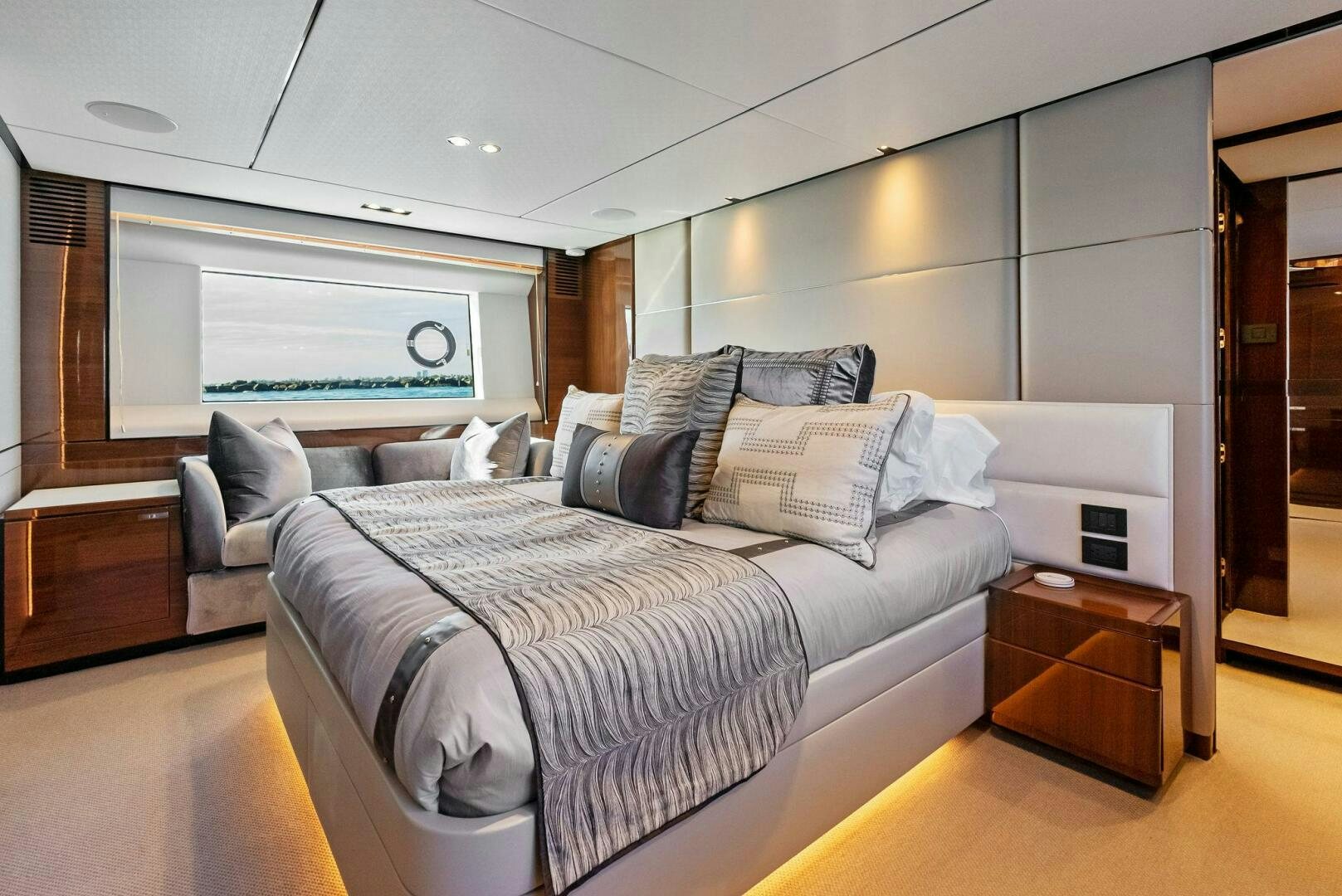 a bedroom with a bed and a desk aboard AMICI Yacht for Sale