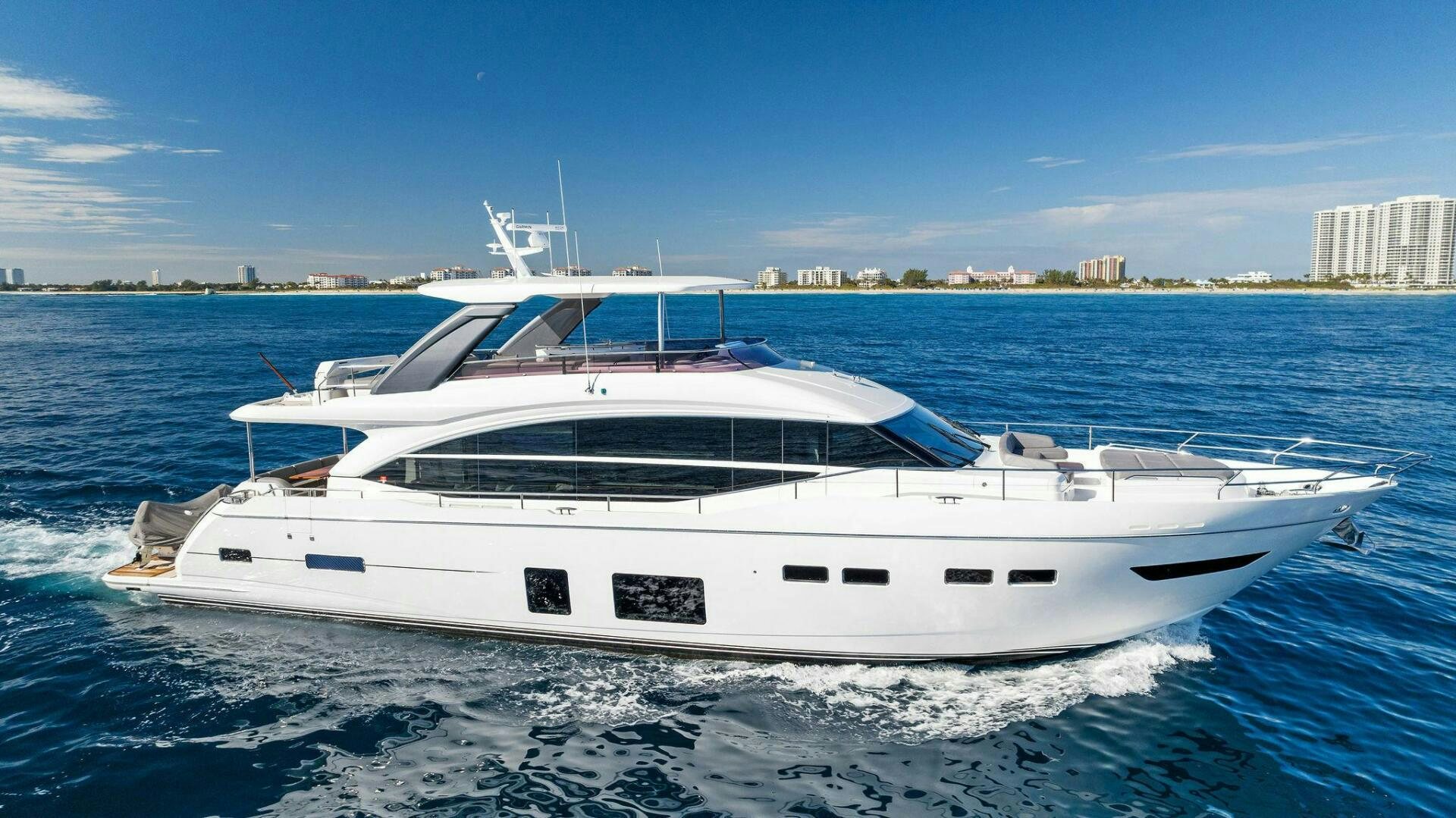 a white yacht on the water aboard AMICI Yacht for Sale