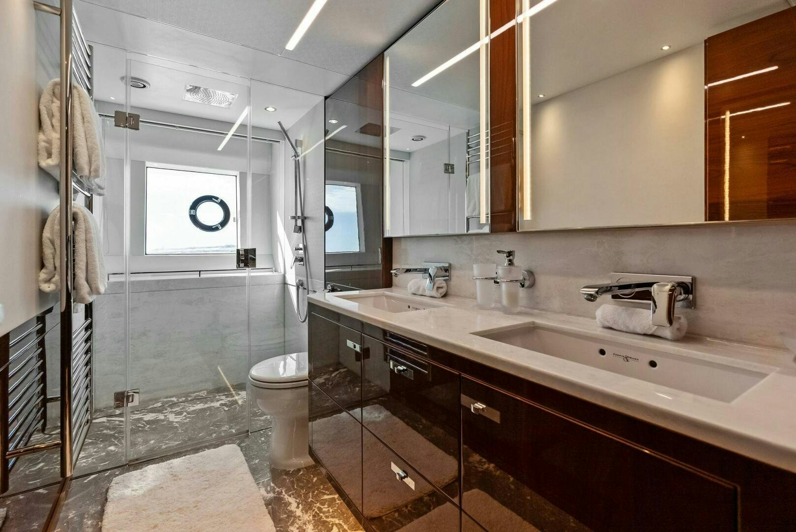 a bathroom with a sink and a mirror aboard AMICI Yacht for Sale