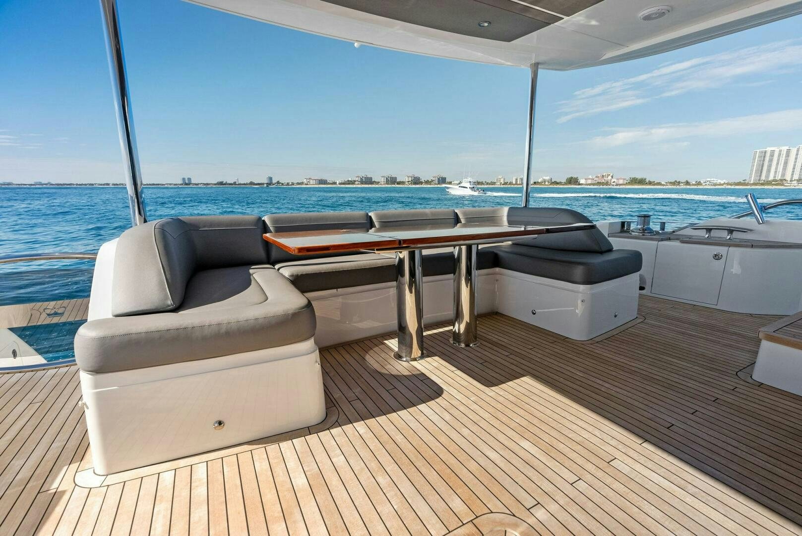 a pool table and couches on a deck overlooking the ocean aboard AMICI Yacht for Sale