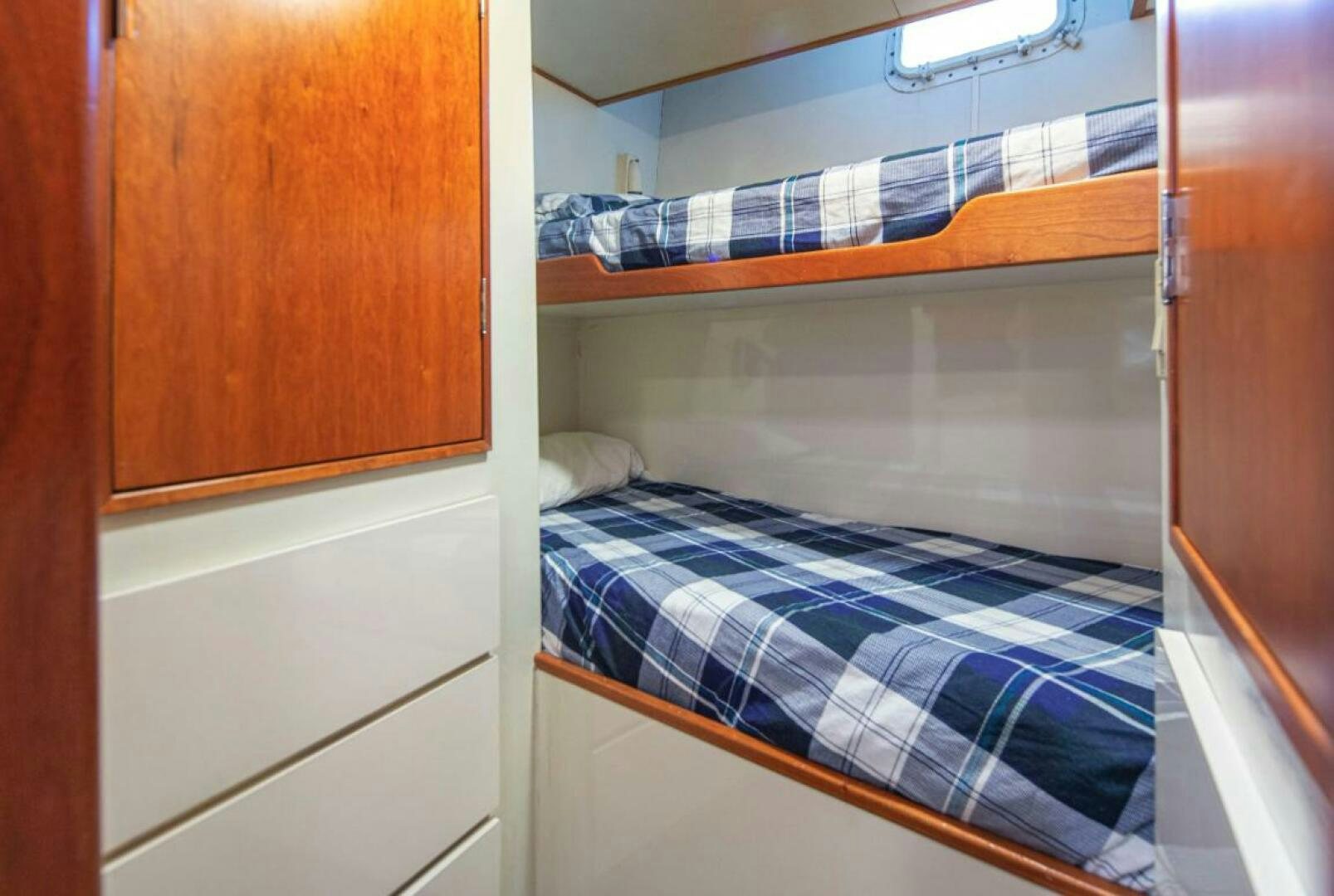 a bed with a blue and white striped blanket aboard GOLDEN EAGLE Yacht for Sale