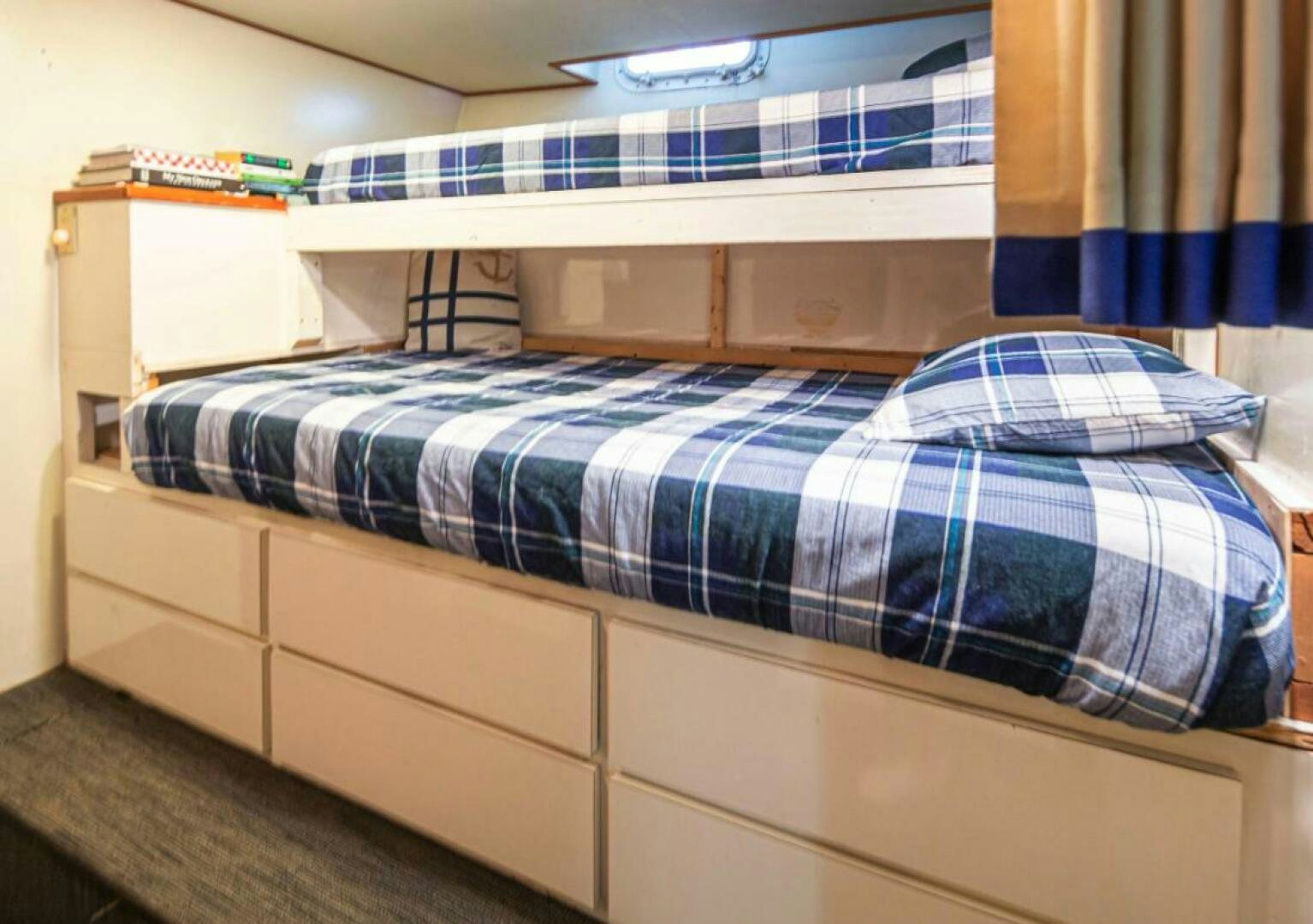 a bed with a blue and white striped blanket aboard GOLDEN EAGLE Yacht for Sale