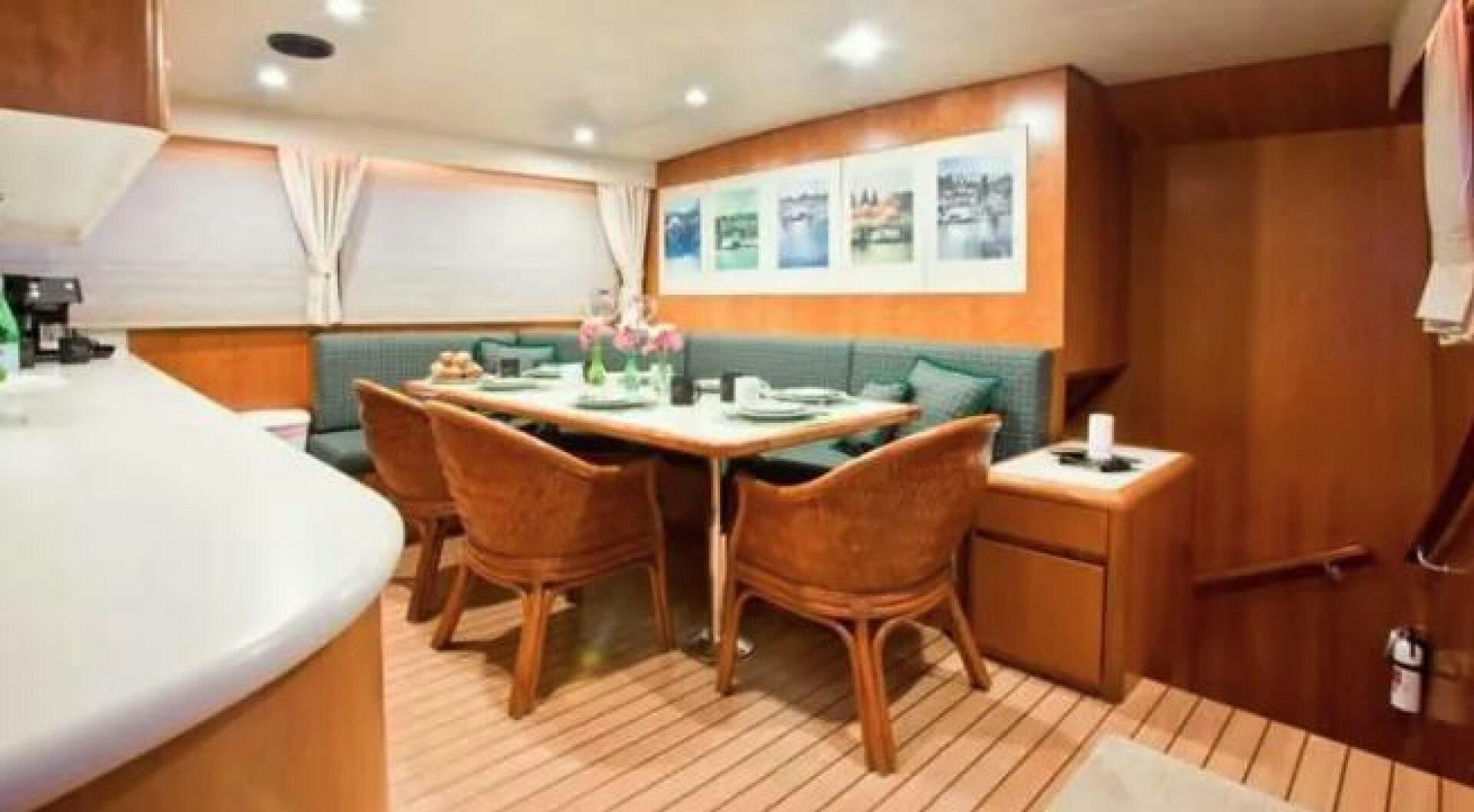 a room with a table and chairs aboard GOLDEN EAGLE Yacht for Sale