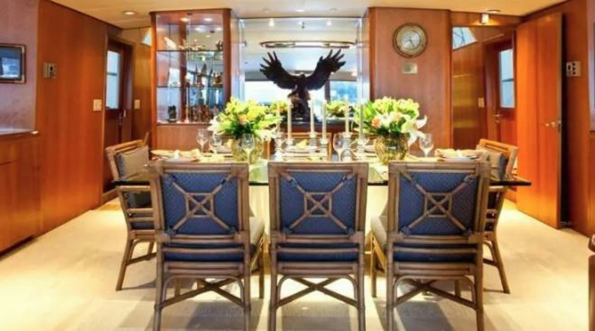 a dining room with chairs and a table aboard GOLDEN EAGLE Yacht for Sale
