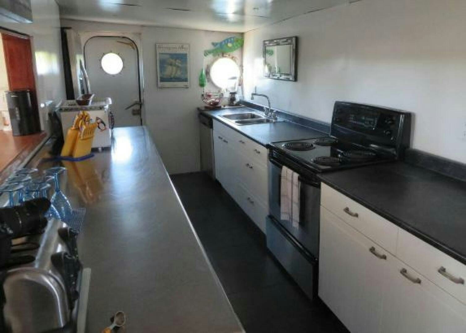 a kitchen with a black stove aboard PRESCOTONT Yacht for Sale