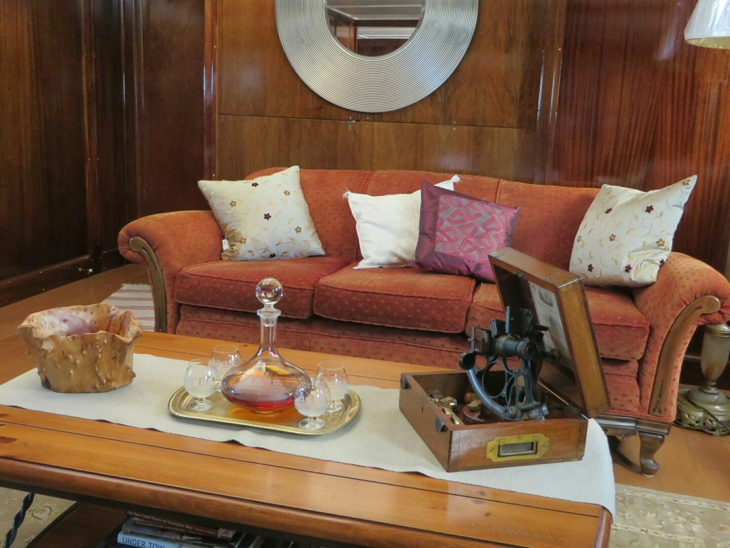 a living room with a red couch and a coffee table aboard PRESCOTONT Yacht for Sale