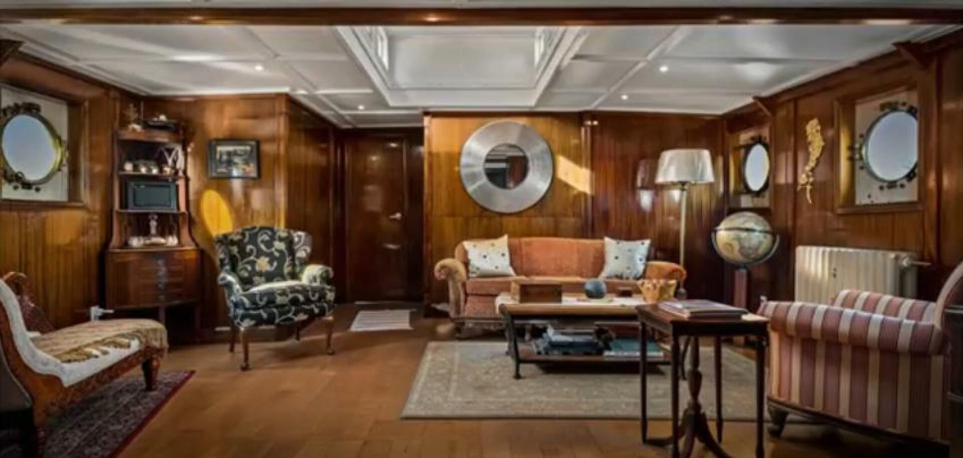 a living room with a couch and a coffee table aboard PRESCOTONT Yacht for Sale