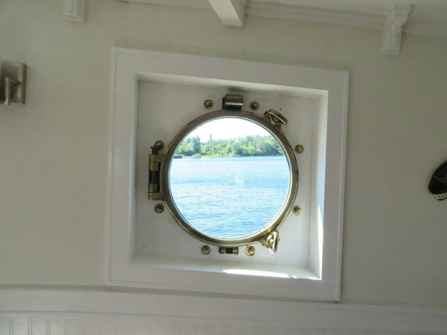 a window with a view of a forest aboard PRESCOTONT Yacht for Sale