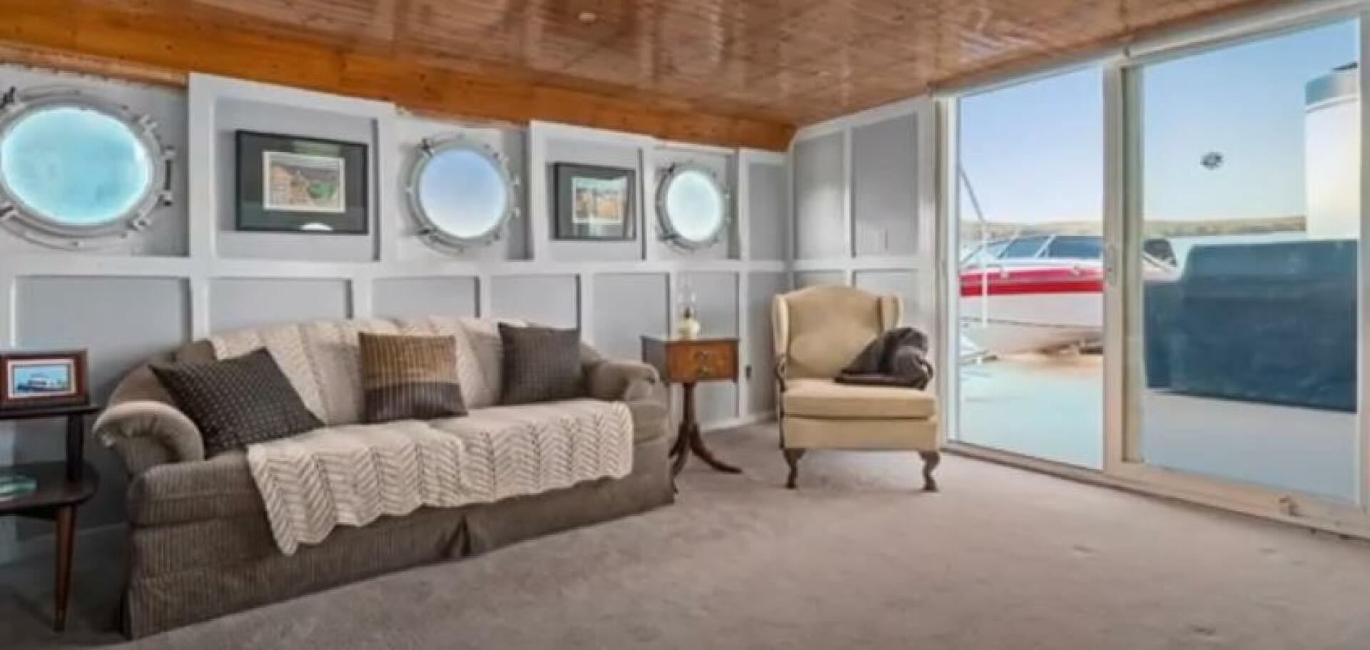 a living room with a couch and a window aboard PRESCOTONT Yacht for Sale