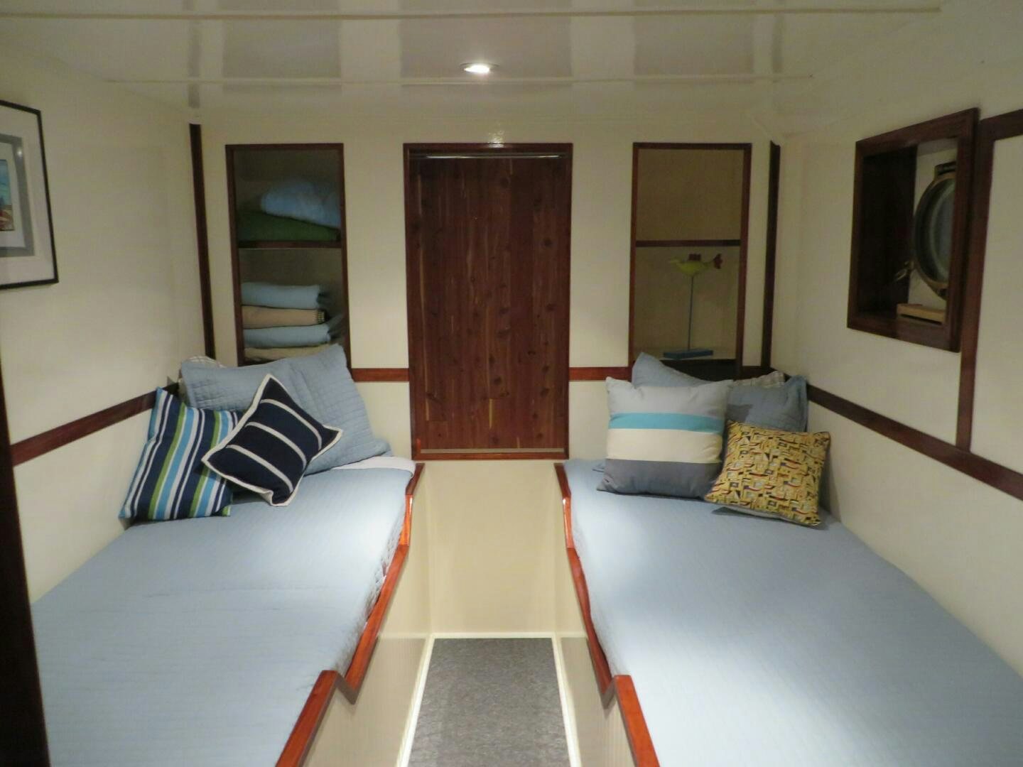 a room with beds and a mirror aboard PRESCOTONT Yacht for Sale