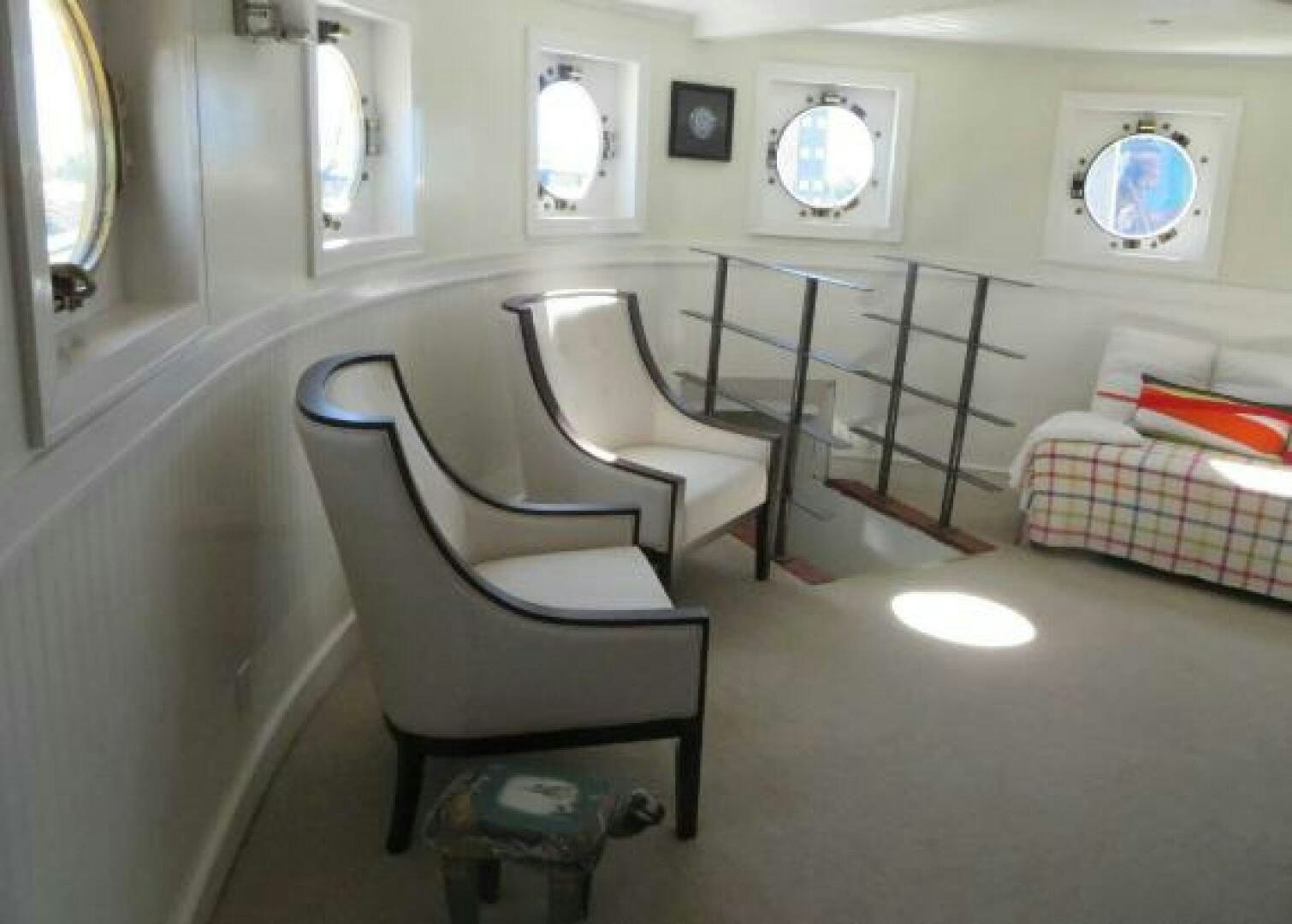 a room with chairs and a table aboard PRESCOTONT Yacht for Sale