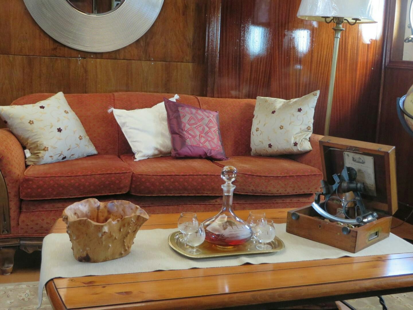 a living room with a red couch aboard PRESCOTONT Yacht for Sale