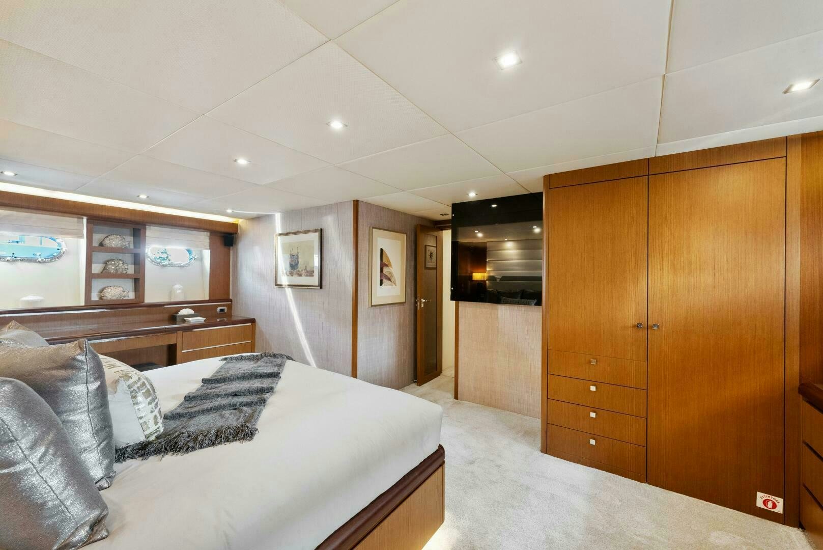 a bedroom with a bed and a closet aboard PRINCESS LONA Yacht for Sale
