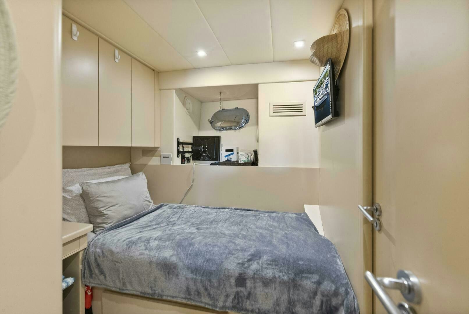 a bedroom with a bed and a television on the wall aboard PRINCESS LONA Yacht for Sale