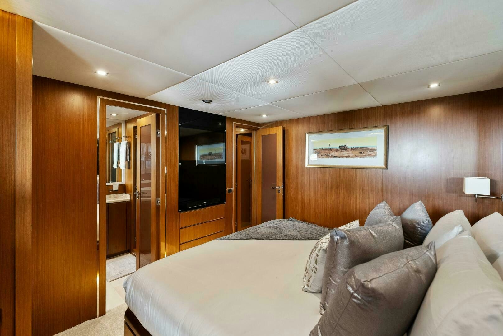 a bedroom with a bed and a television aboard PRINCESS LONA Yacht for Sale