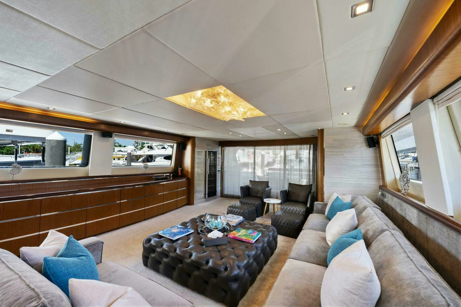 a living room with a large sofa and a large fireplace aboard PRINCESS LONA Yacht for Sale