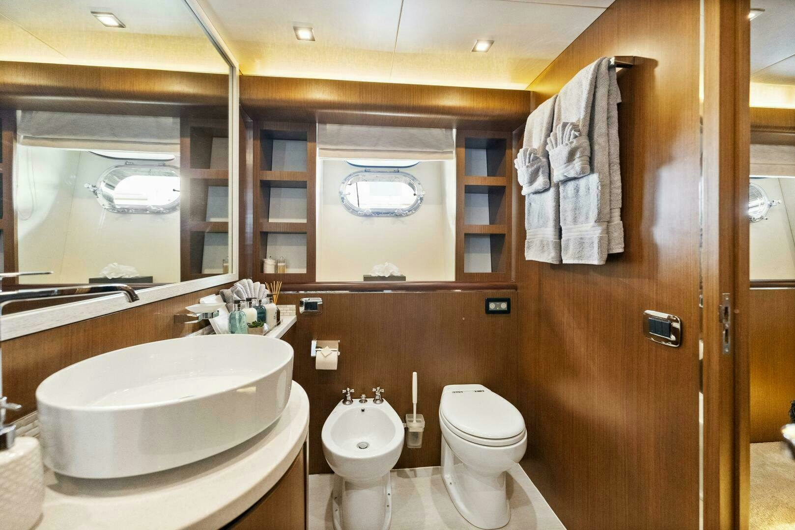 a bathroom with a sink toilet and a mirror aboard PRINCESS LONA Yacht for Sale