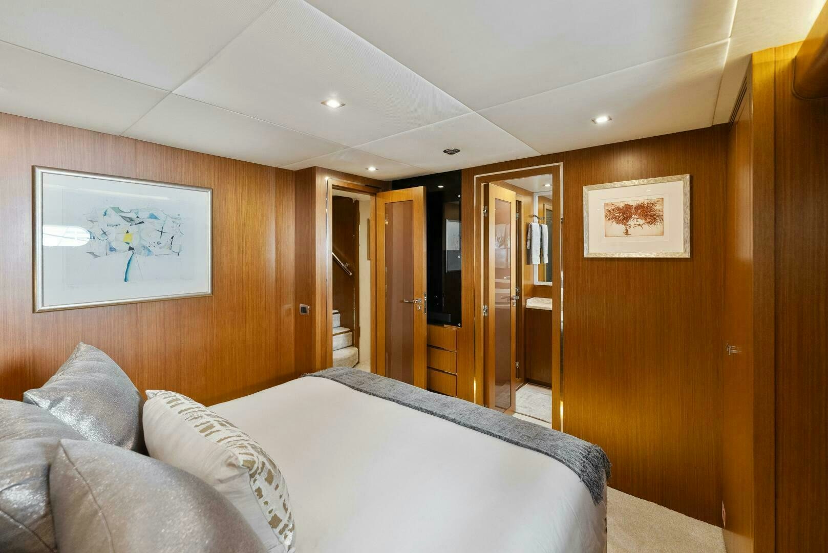 a bedroom with a bed and a mirror aboard PRINCESS LONA Yacht for Sale