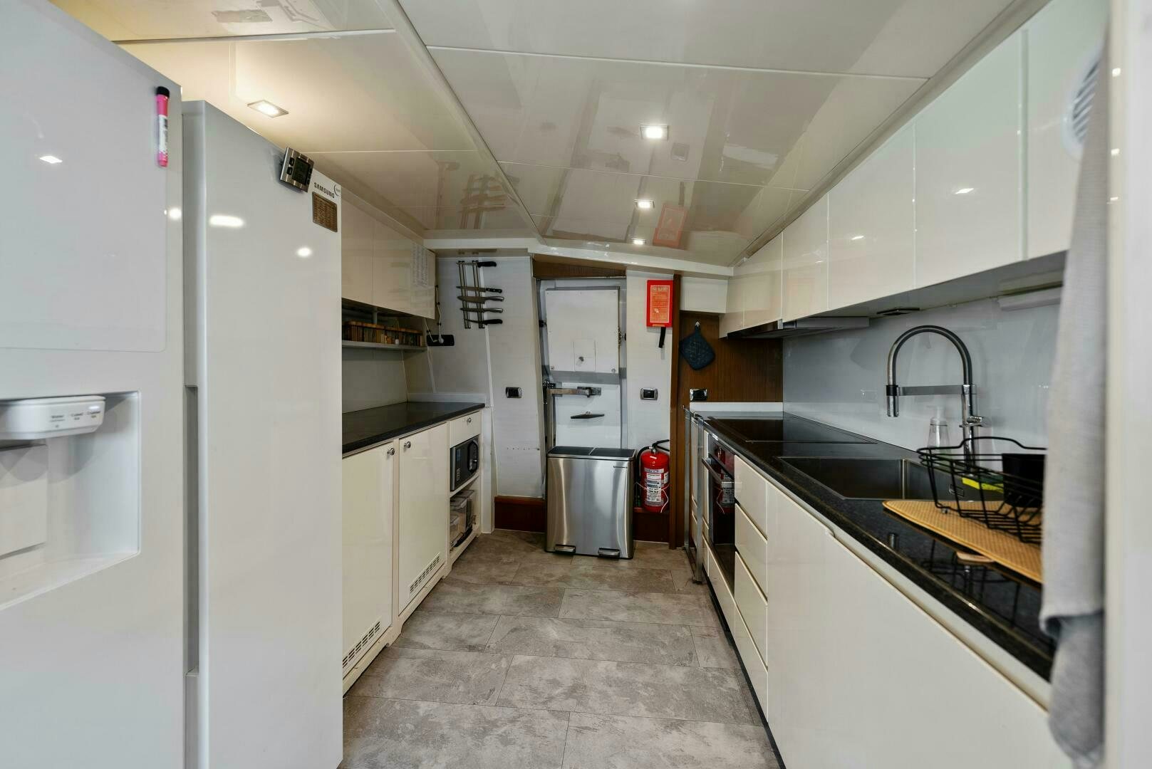 a kitchen with white cabinets aboard PRINCESS LONA Yacht for Sale