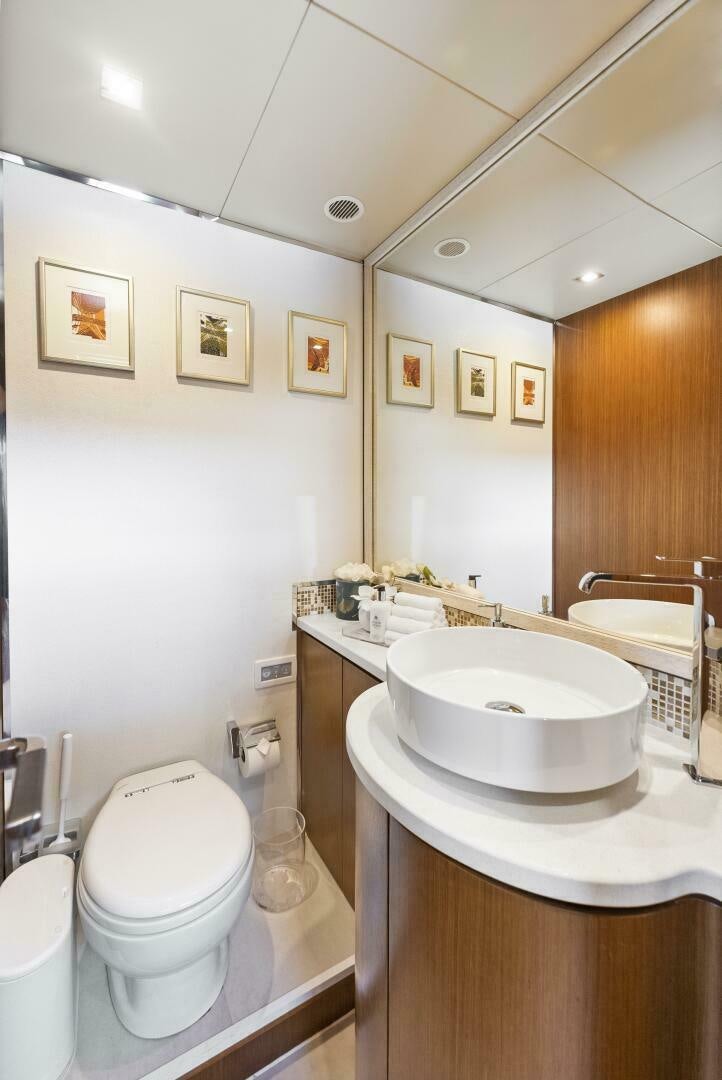 a bathroom with a toilet and sink aboard PRINCESS LONA Yacht for Sale