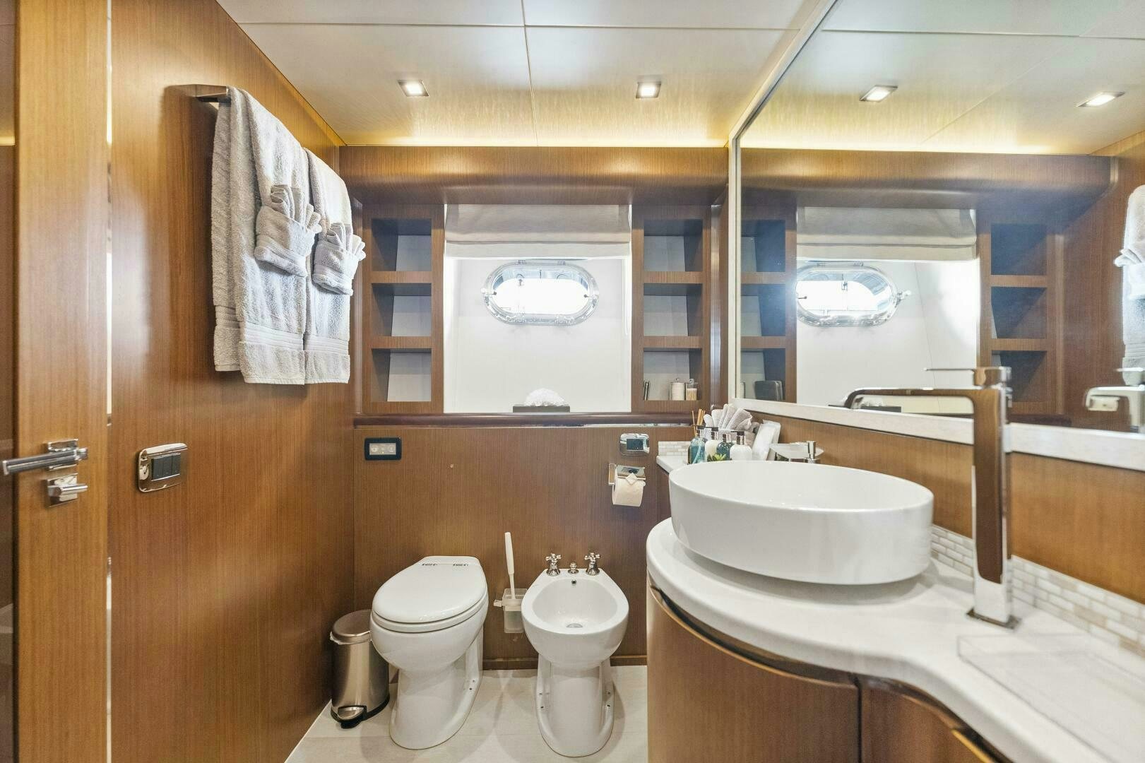 a bathroom with a sink toilet and a mirror aboard PRINCESS LONA Yacht for Sale
