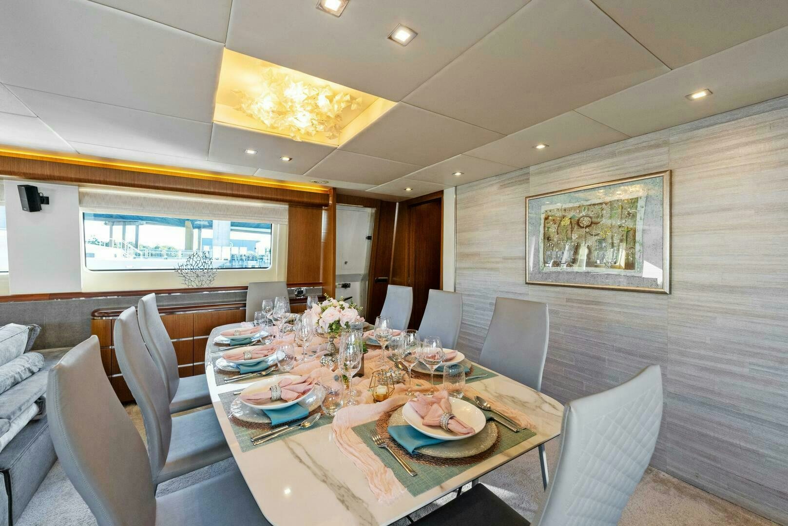 a dining table with plates and glasses aboard PRINCESS LONA Yacht for Sale