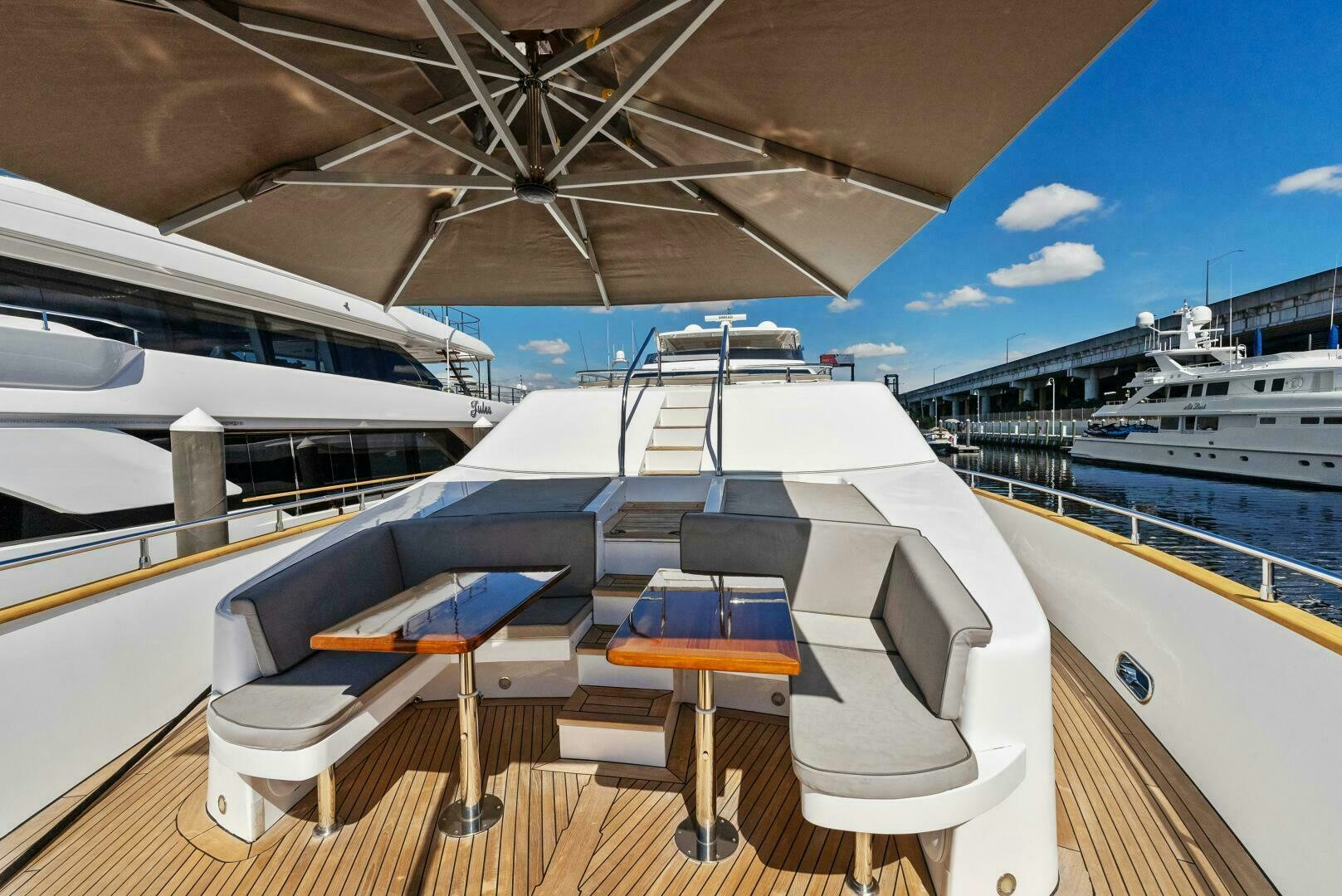 a deck with a table and chairs on it aboard PRINCESS LONA Yacht for Sale