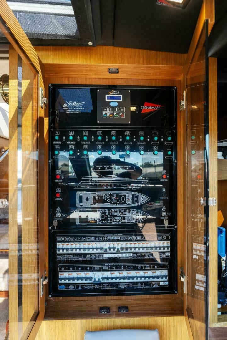 a wood cabinet with a black and white display of video games aboard PRINCESS LONA Yacht for Sale