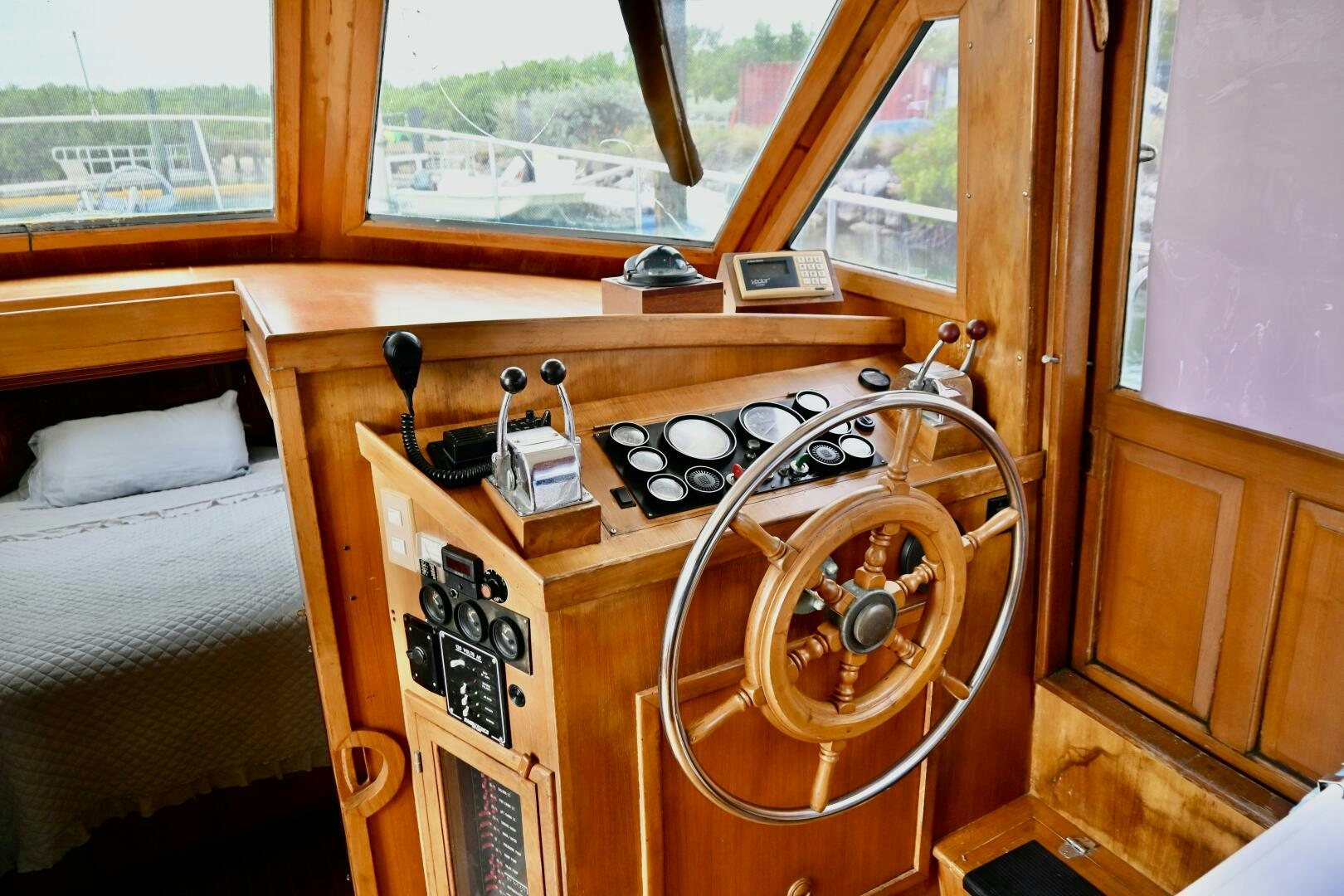 a wooden table with a fan and a bed aboard LITTLE BAYOU Yacht for Sale