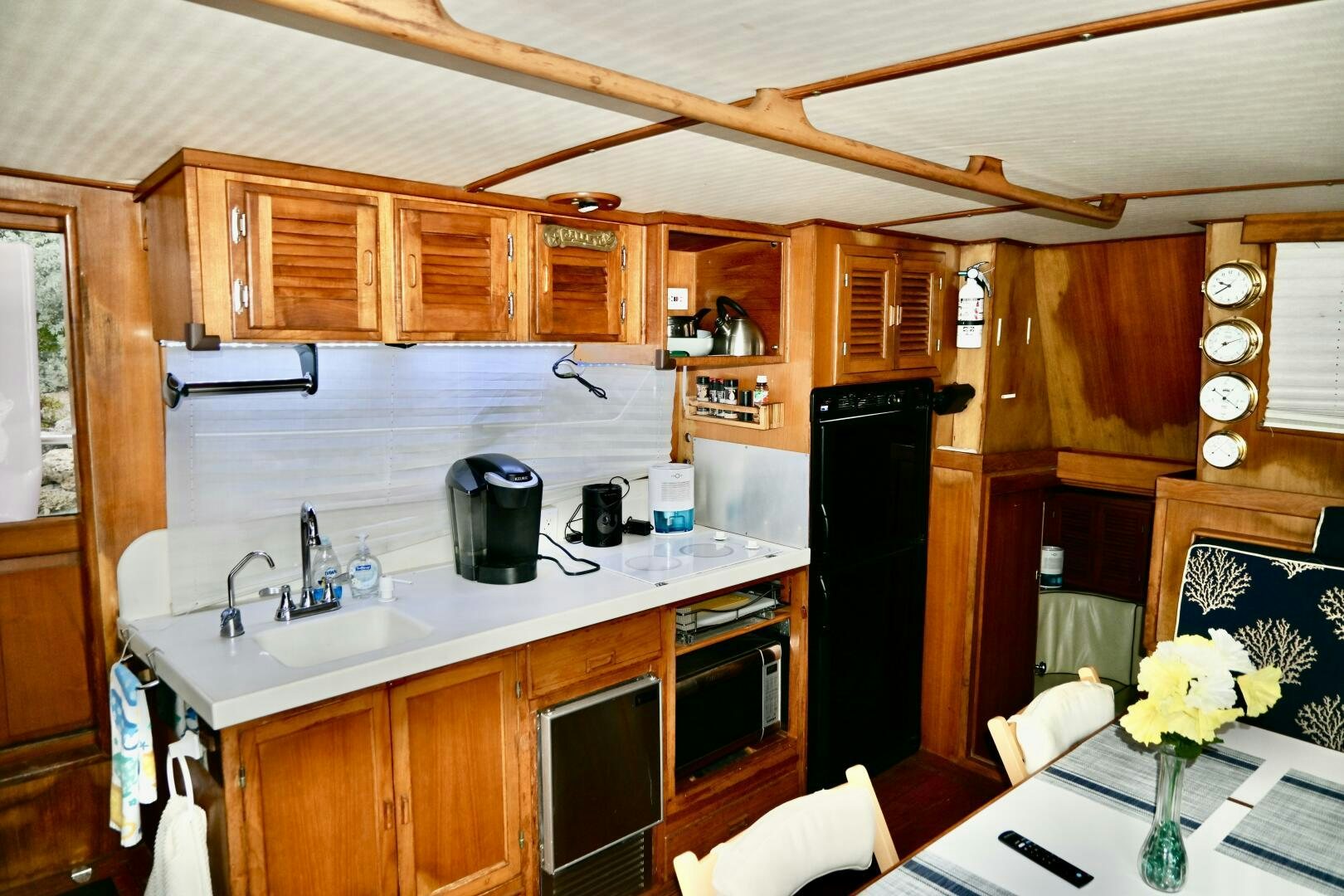 a kitchen with wooden cabinets aboard LITTLE BAYOU Yacht for Sale