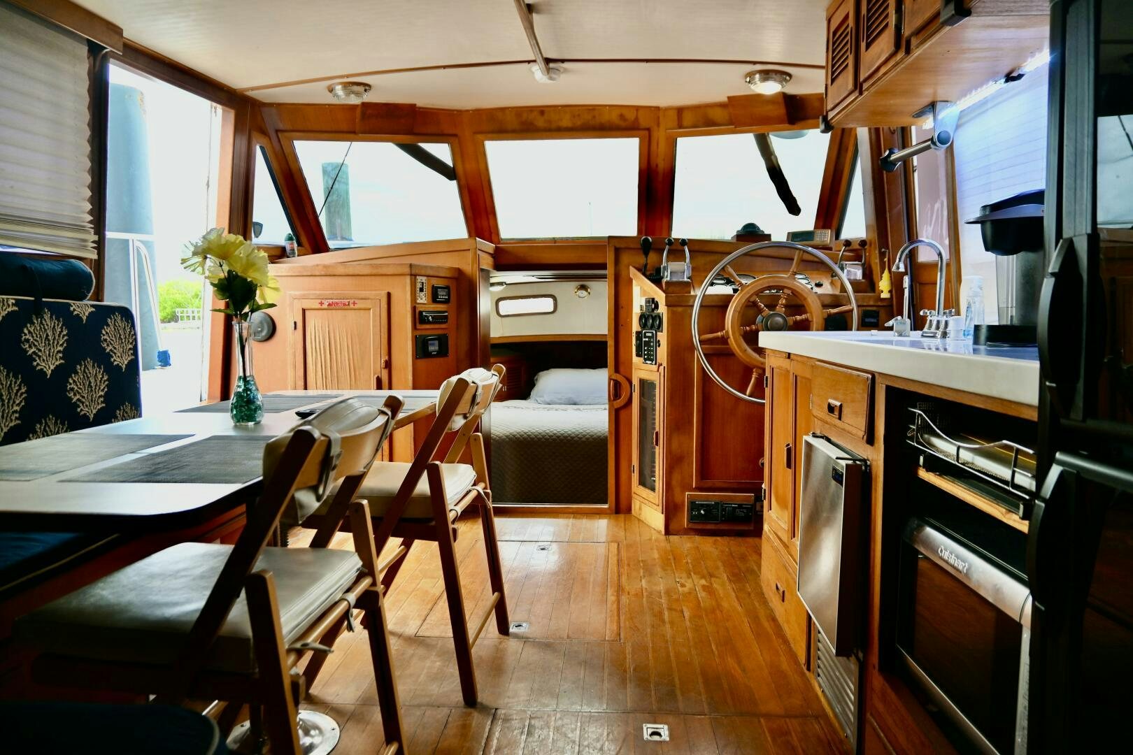 a kitchen with a dining table and chairs aboard LITTLE BAYOU Yacht for Sale